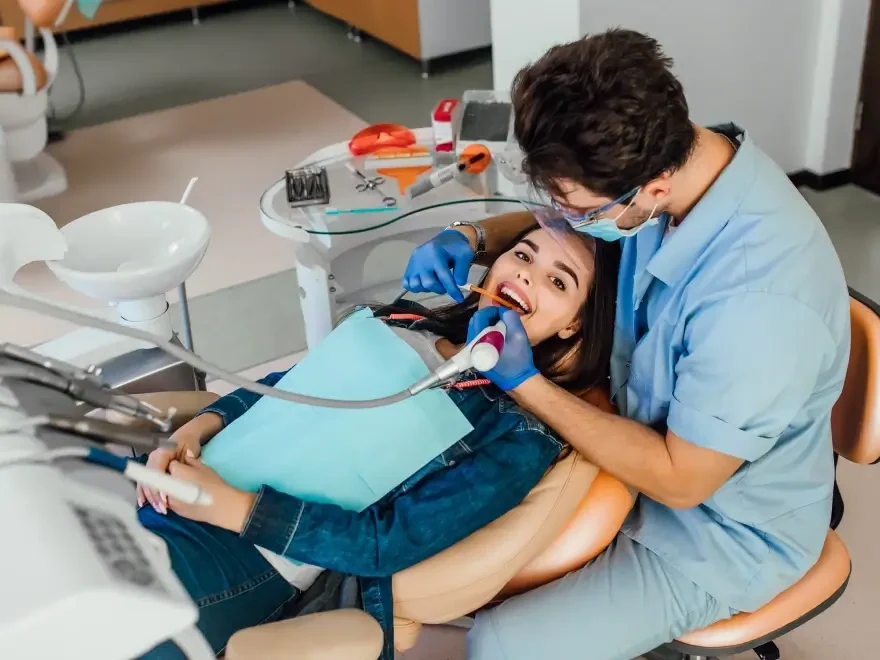 A dentist treating a relaxed patient in the chair